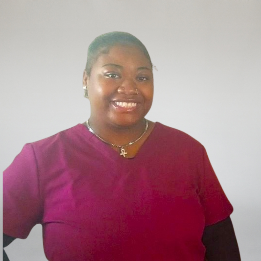 A headshot photo of a CNA students that is dressed in scrubs. 