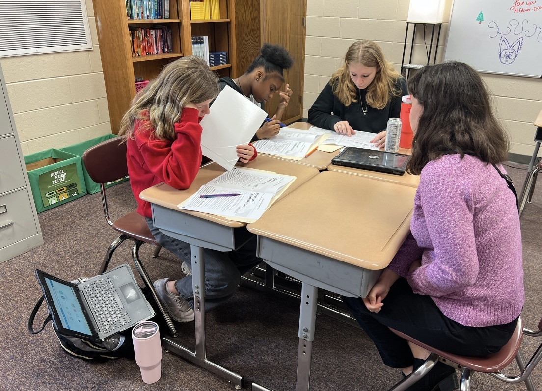 Group of students sitting at desks completing an activity