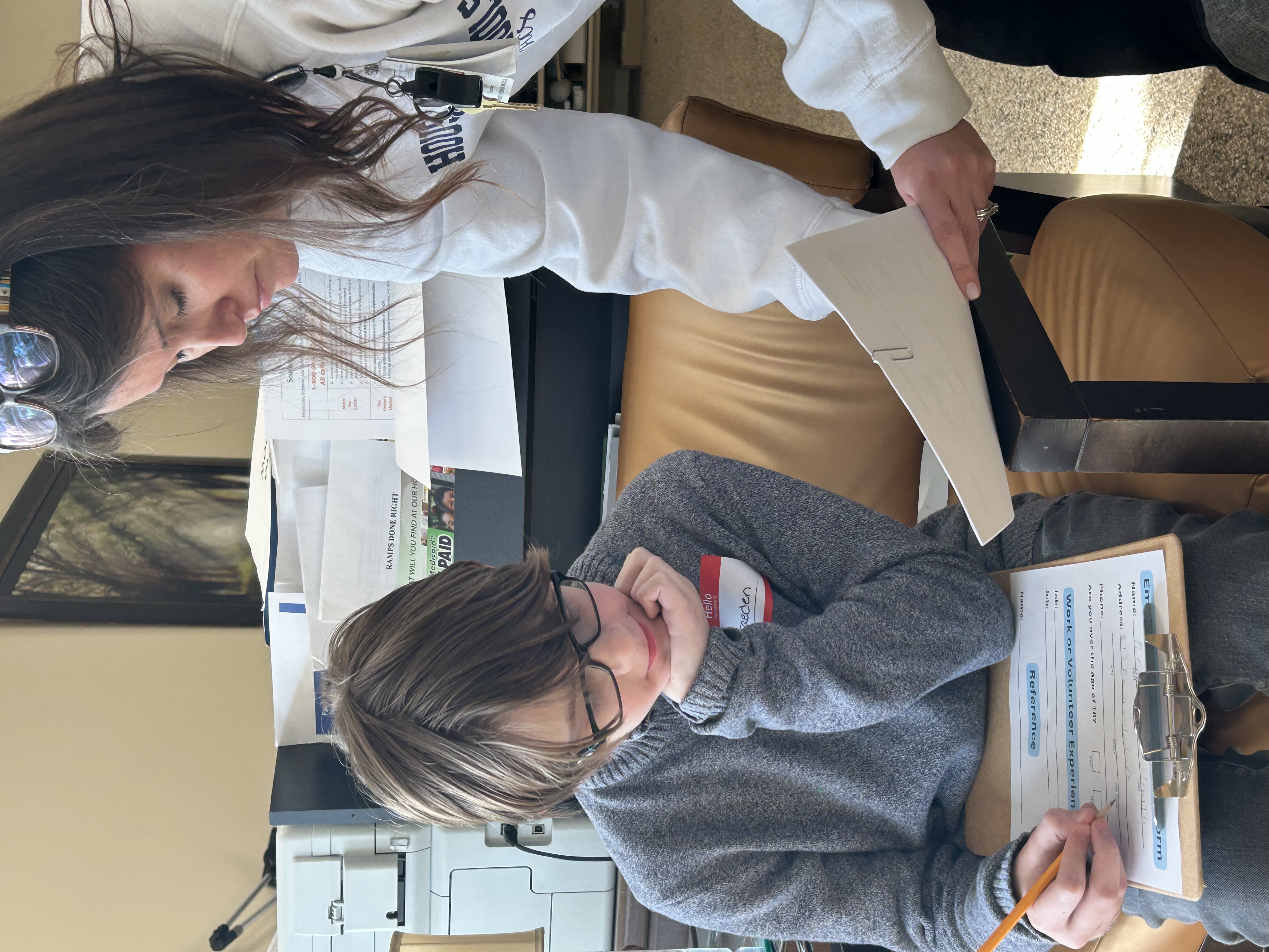 woman instructor discussing an activity with a male student