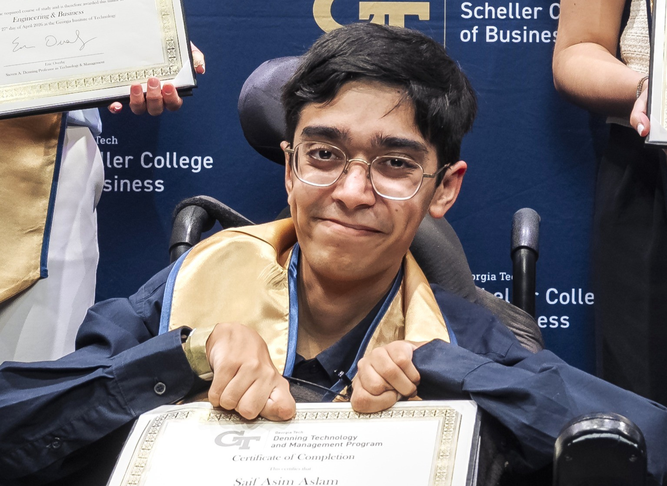 A man holding a certificate in his hands. 