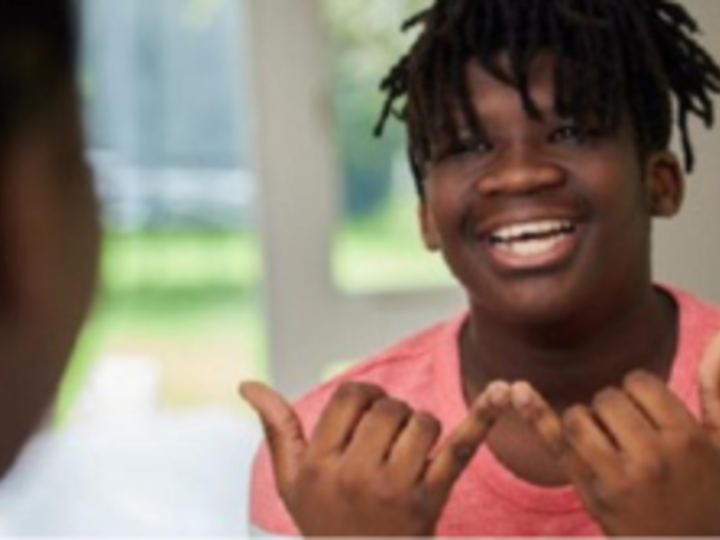 Young man using sign language