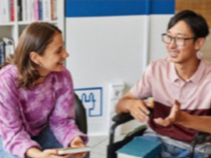 Two people smiling, talking