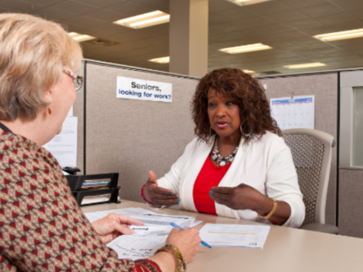 A Goodwill Southern Rivers employee talking to an older woman. 