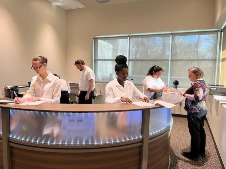 RWS students training on how to be hotel front desk agents. 