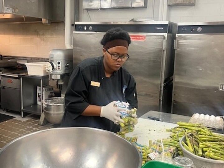  A student who is in the kitchen and is cooking. 