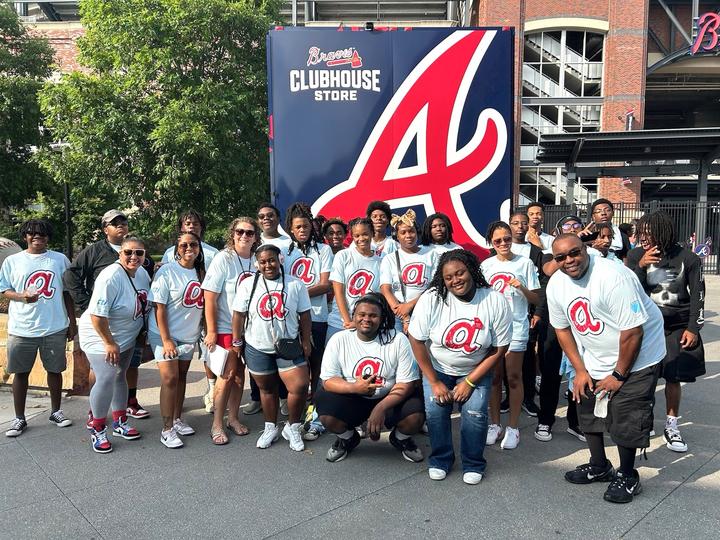 A group photo of students and staff at the Atlanta Braves event. 