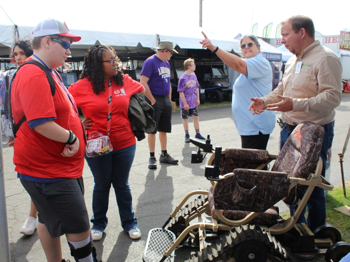 Students in the red shirts are listening to the services GVRA offers for farmers.