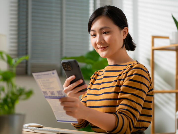 asian woman scanning with phone