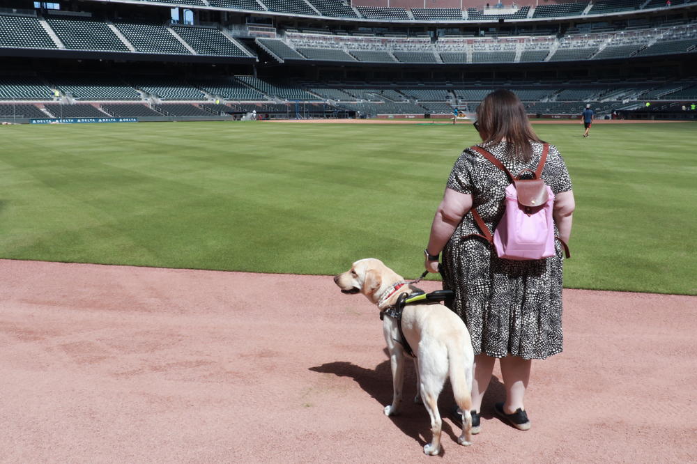 Katie Hearn stands on the outfield warning track at SunTrust Park