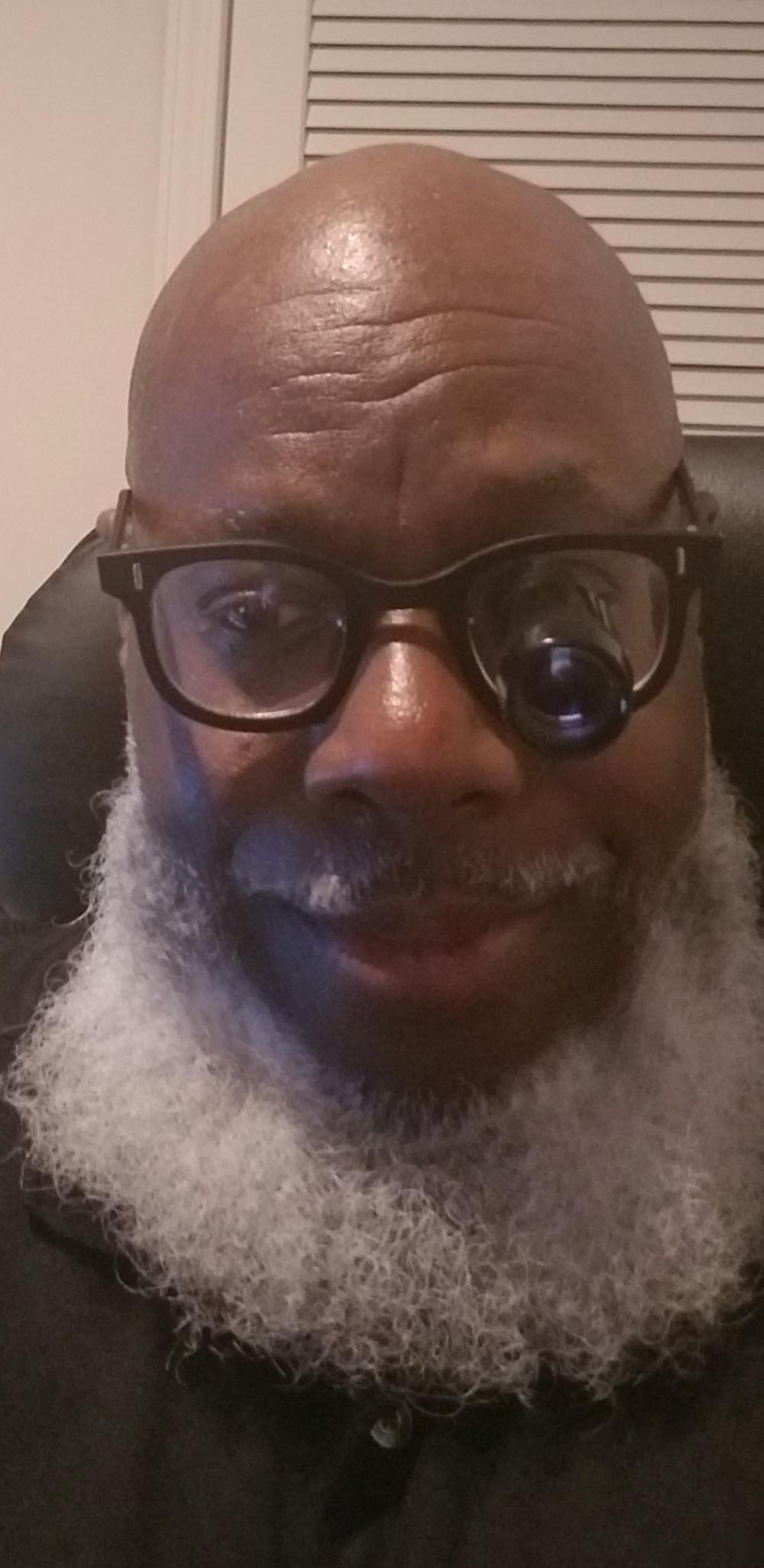 Ken Armstrong wears glasses and has a white beard
