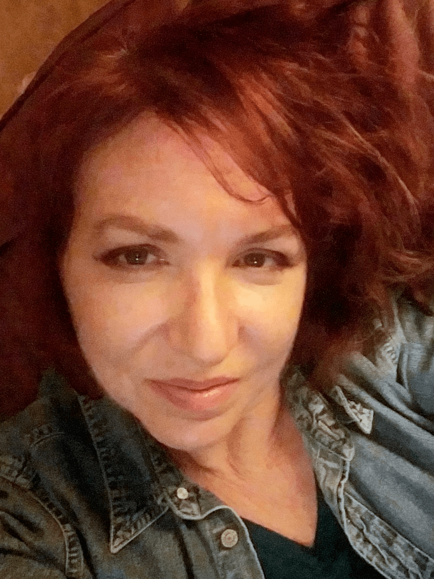 Amy Layton looks at the camera while wearing a denim shirt