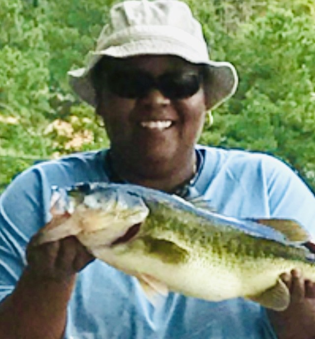 Celeste Harris poses with a fish she caught