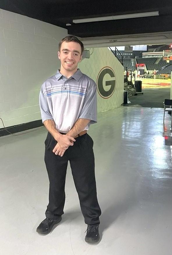 Pearson smiling near player entrance in stadium 