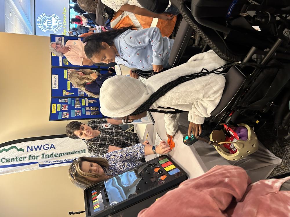 Students playing a game at a booth with adult leaders