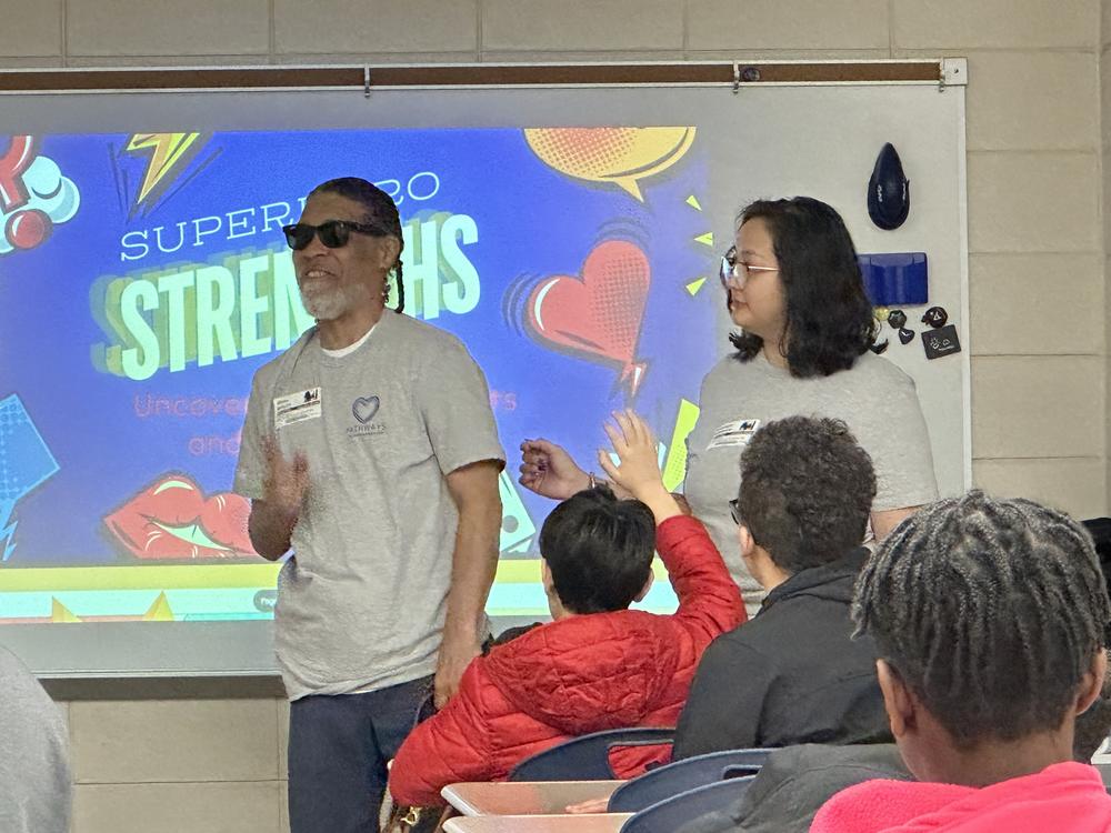 A man who is blind facilitating a classroom session with students