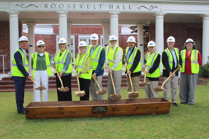 RWS staff with yellow vest and construction hats picking up dirt from their shovles.  