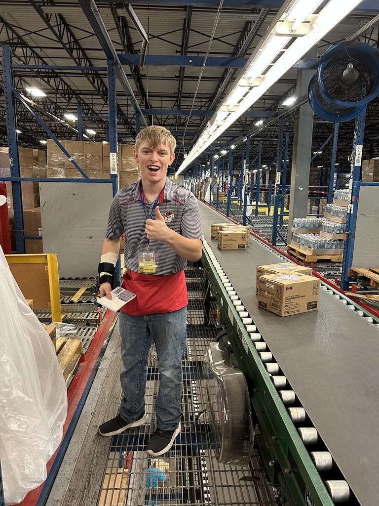 A photo of Kaleb working in the warehouse.