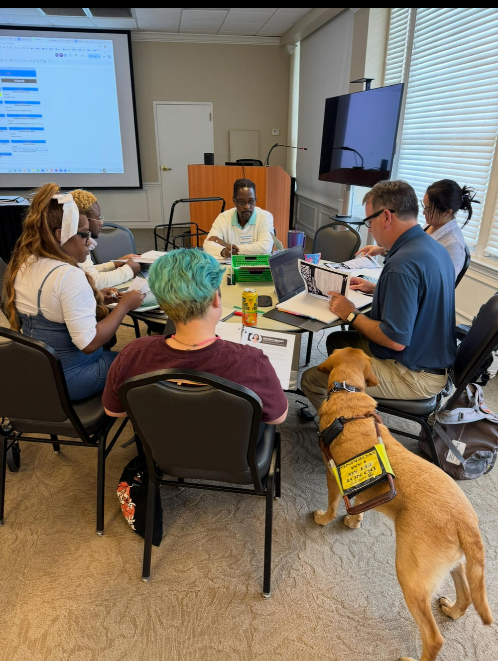 Group of people with laptops and computers in a group activity