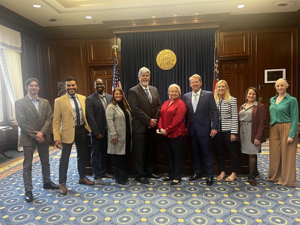A group photo of people in the governor's office.