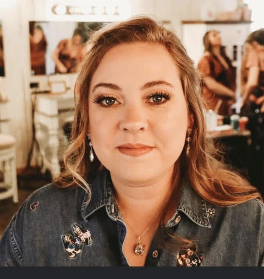 A headshot photo of a woman wearing a jean jacket.