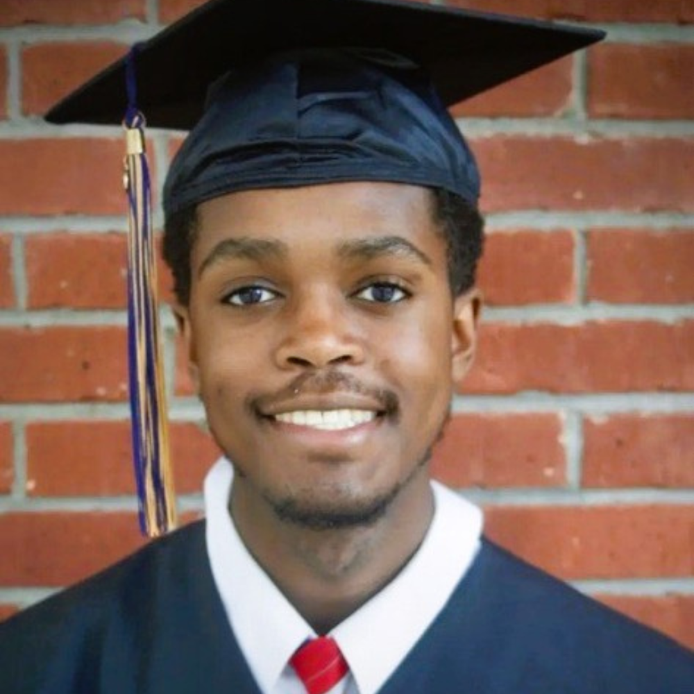 A headshot photo of a man with a graduation cap.