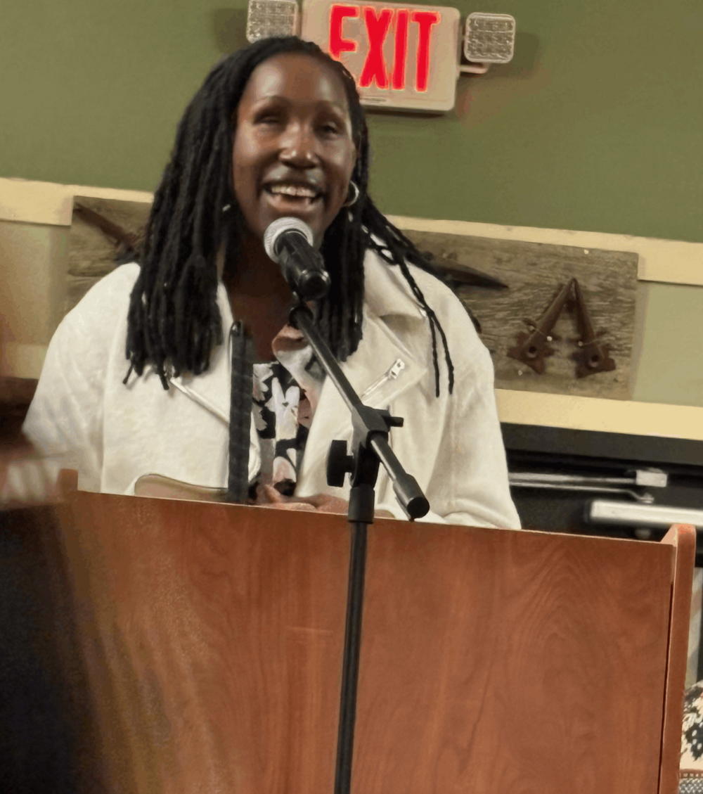 A woman speaking in a microphone. 