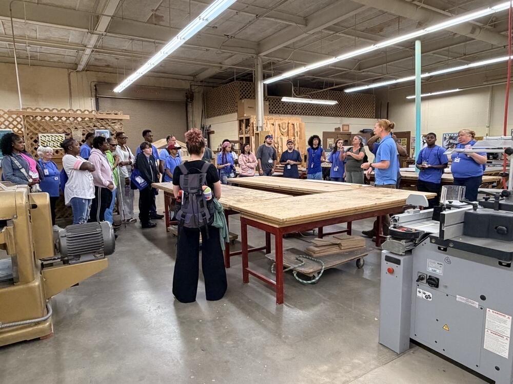 Students gather in an industrial shop to learn about potential careers