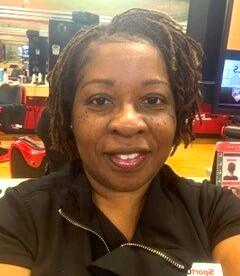 A woman taking a selfie wearing a black shirt and is smiling.