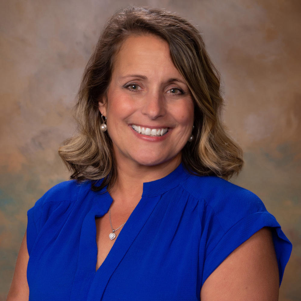 Arlene Fowler headshot image in blue blouse 