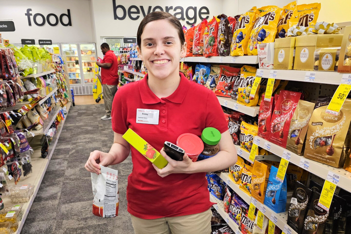 A RWS student wearing a red shirt and holding food items in their hands. 